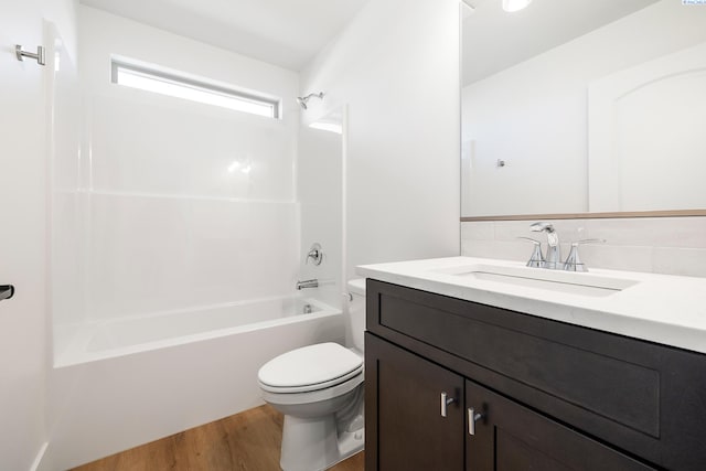 6562 W 30th Pl, Kennewick, WA 99338 - bathroom featuring toilet, wood finished floors, vanity, and shower / tub combination