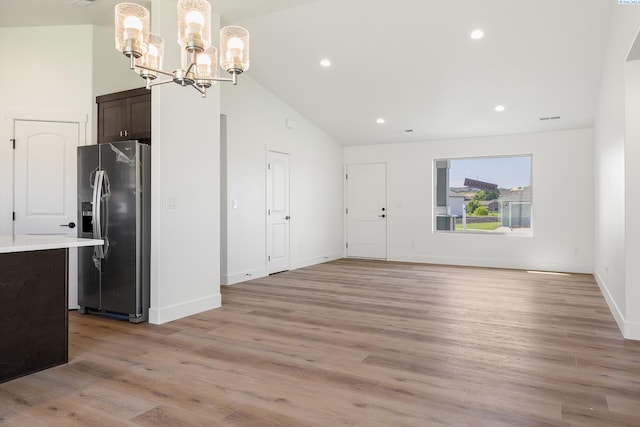 6562 W 30th Pl, Kennewick, WA 99338 - kitchen featuring stainless steel fridge, lofted ceiling, a chandelier, dark brown cabinetry, and light wood-style flooring