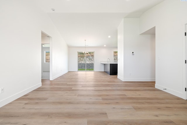 6562 W 30th Pl, Kennewick, WA 99338 - unfurnished living room featuring light wood-style floors, baseboards, a chandelier, and recessed lighting