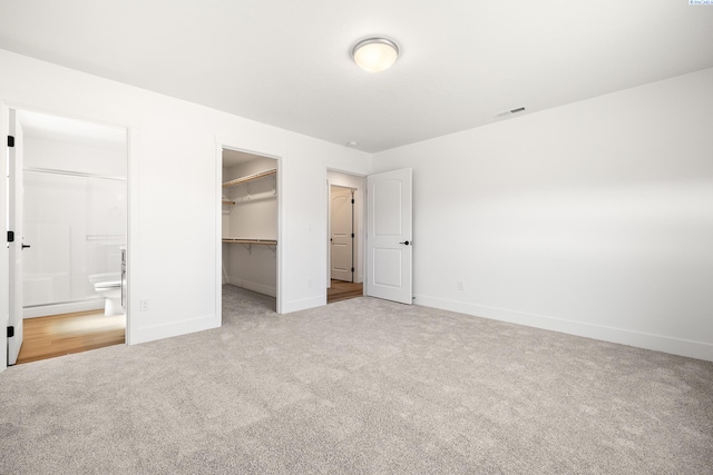 6562 W 30th Pl, Kennewick, WA 99338 - unfurnished bedroom with carpet floors, baseboards, a spacious closet, and a closet