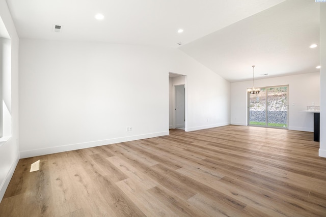 6562 W 30th Pl, Kennewick, WA 99338 - unfurnished living room with a chandelier, lofted ceiling, light wood-style flooring, recessed lighting, and baseboards