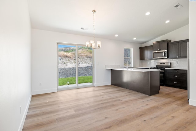 6562 W 30th Pl, Kennewick, WA 99338 - kitchen featuring appliances with stainless steel finishes, a chandelier, baseboards, decorative backsplash, and light countertops