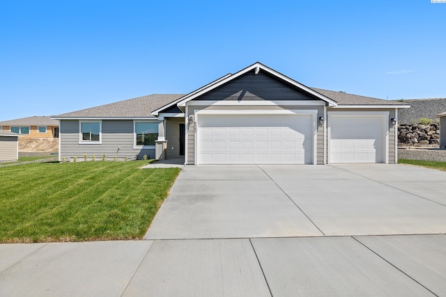 6562 W 30th Pl, Kennewick, WA 99338 - ranch-style home with an attached garage, concrete driveway, a front yard, and a shingled roof
