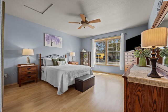 bedroom featuring light wood-type flooring, baseboards, and ceiling fan