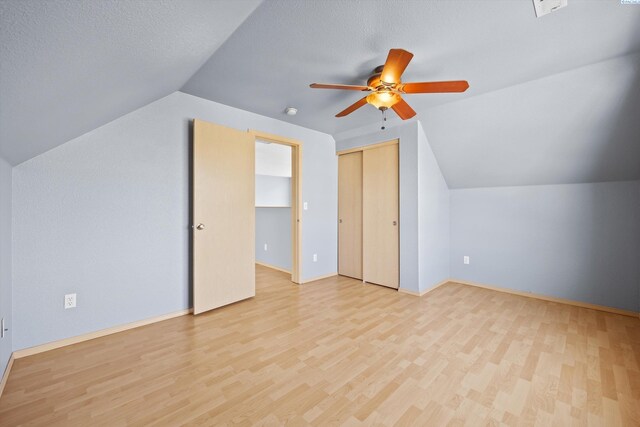 bonus room featuring baseboards, ceiling fan, vaulted ceiling, and wood finished floors