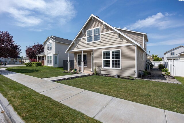 bungalow-style home featuring fence and a front lawn