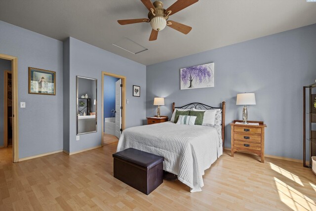 bedroom featuring baseboards, attic access, and light wood-style floors