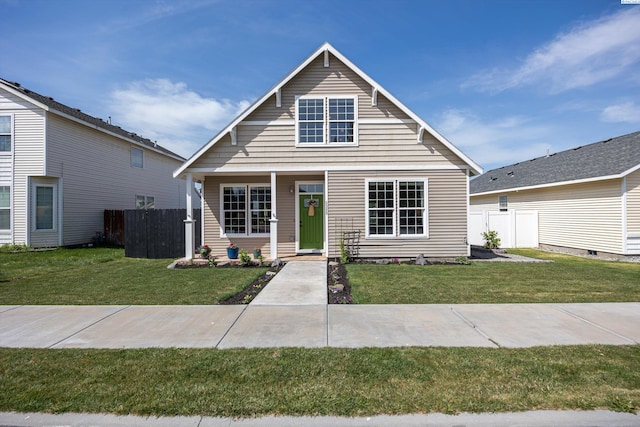 bungalow-style house featuring a front lawn and fence
