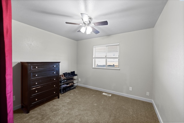 carpeted bedroom with visible vents, baseboards, and ceiling fan
