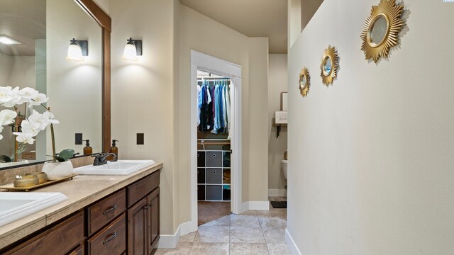 1905 S Harrison St, Kennewick, WA 99338 - full bathroom featuring double vanity, baseboards, a spacious closet, and tile patterned floors