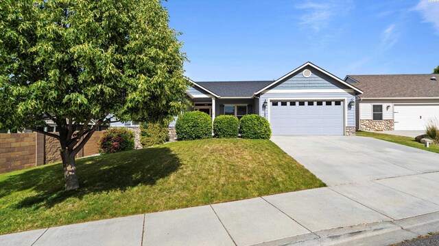 1905 S Harrison St, Kennewick, WA 99338 - single story home with an attached garage, driveway, and stone siding