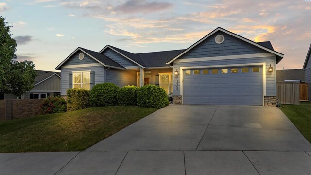 1905 S Harrison St, Kennewick, WA 99338 - ranch-style home with driveway, a garage, and stone siding