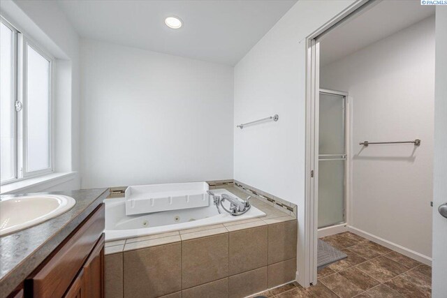 full bath with a jetted tub, a stall shower, recessed lighting, and vanity