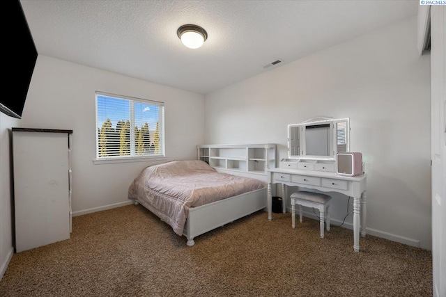 carpeted bedroom with a textured ceiling, visible vents, and baseboards