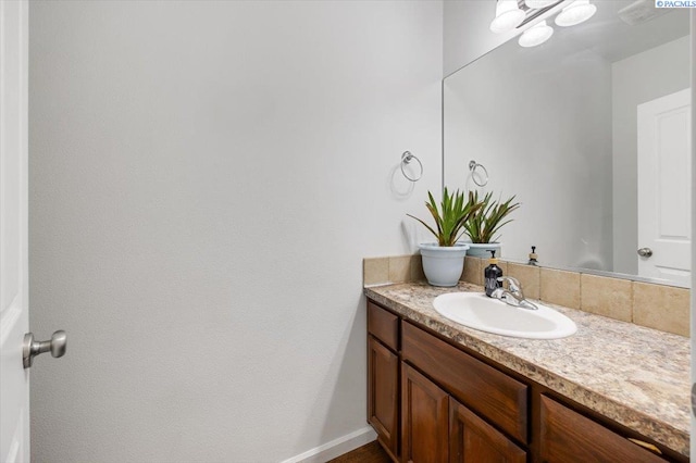 bathroom featuring vanity and baseboards