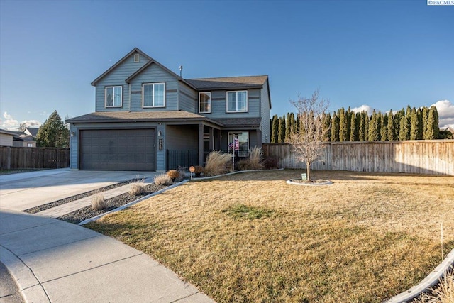 traditional home featuring a garage, driveway, a front yard, and fence