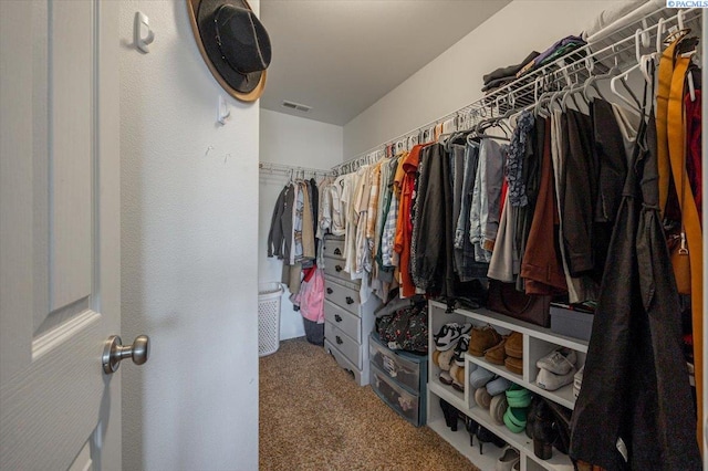 walk in closet with carpet floors and visible vents