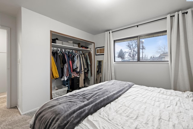 bedroom with carpet, a closet, and baseboards