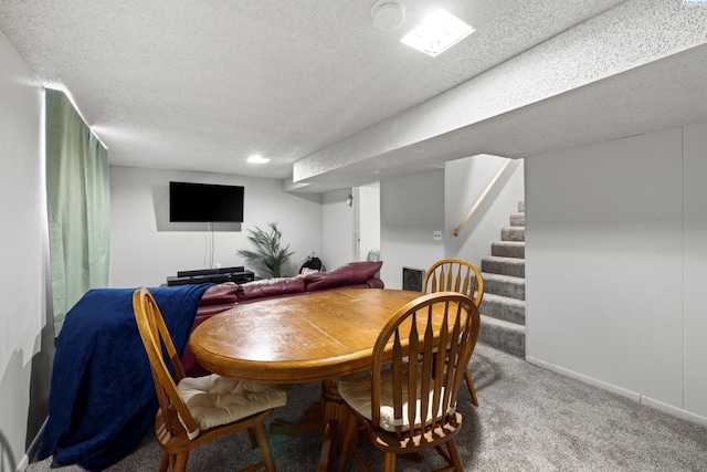 dining area with carpet floors, visible vents, stairway, a textured ceiling, and baseboards