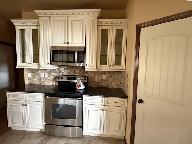 483 Aimee Dr, Richland, WA 99352 - kitchen with appliances with stainless steel finishes, tasteful backsplash, cream cabinetry, and light tile patterned floors