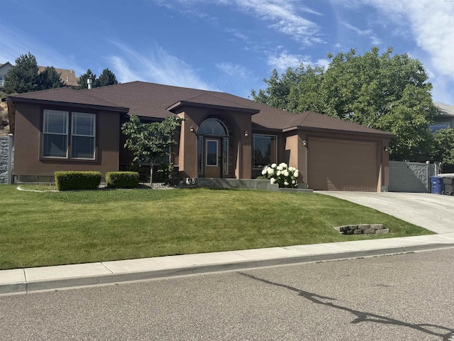 483 Aimee Dr, Richland, WA 99352 - view of front of property with driveway, stucco siding, an attached garage, and a front yard