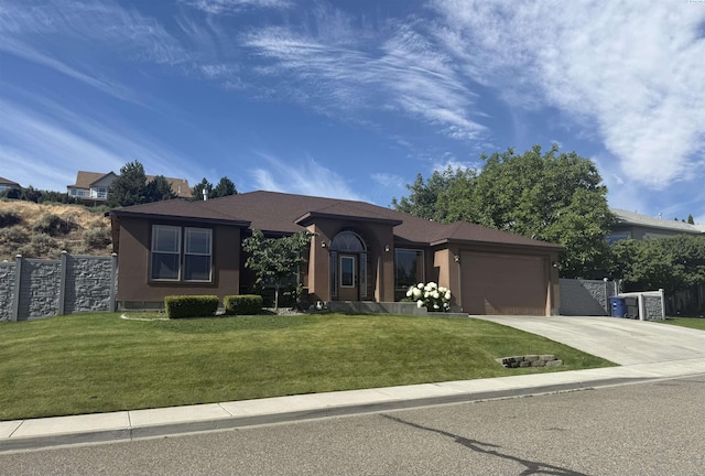 483 Aimee Dr, Richland, WA 99352 - view of front of home featuring concrete driveway, an attached garage, and stucco siding