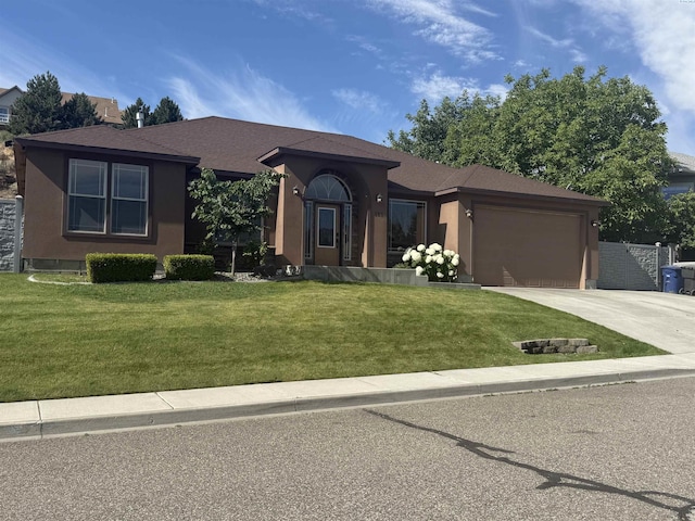 483 Aimee Dr, Richland, WA 99352 - ranch-style house with concrete driveway, a garage, a front lawn, and stucco siding