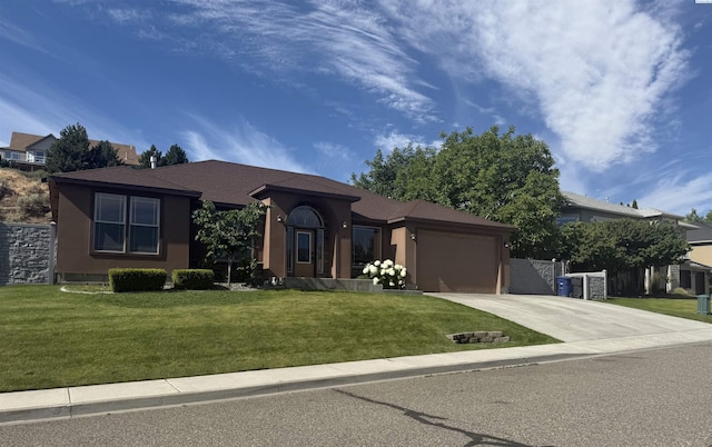 483 Aimee Dr, Richland, WA 99352 - view of front of house featuring driveway, a garage, stucco siding, and a front lawn