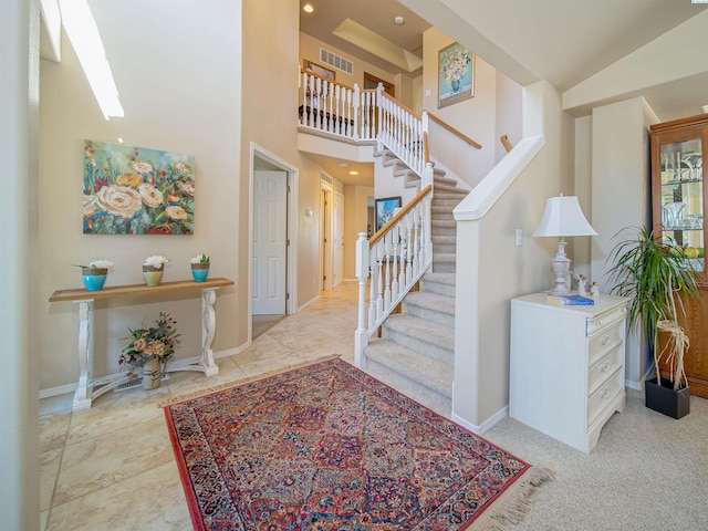 foyer entrance featuring high vaulted ceiling