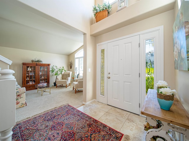 tiled foyer entrance featuring lofted ceiling