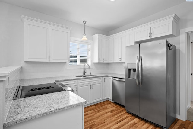 205 W 8th St, Colfax, WA 99111 - kitchen featuring appliances with stainless steel finishes, light wood-style floors, white cabinets, decorative backsplash, and decorative light fixtures