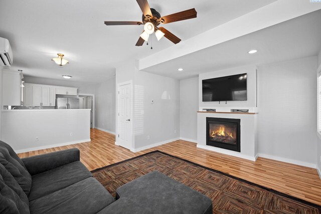 205 W 8th St, Colfax, WA 99111 - living area featuring light wood-style floors, ceiling fan, a glass covered fireplace, recessed lighting, and a wall mounted AC