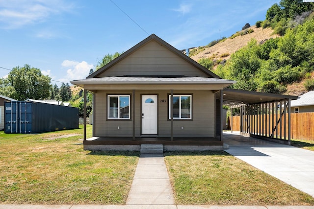 205 W 8th St, Colfax, WA 99111 - view of front facade featuring a porch, a carport, and driveway