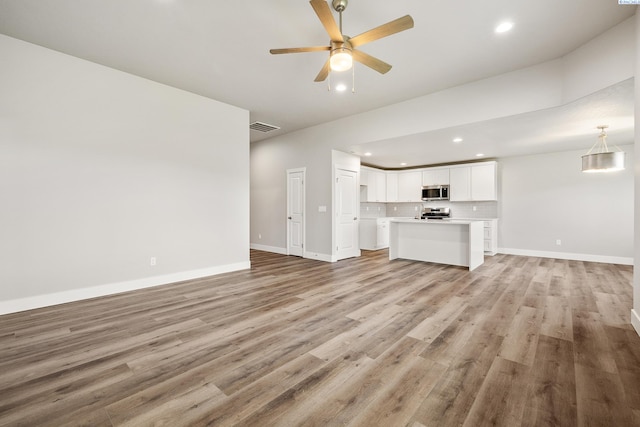3054 S Quay St, Kennewick, WA 99338 - unfurnished living room with recessed lighting, light wood-type flooring, and ceiling fan