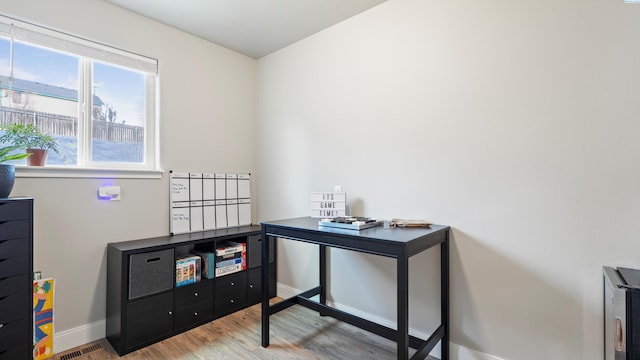 home office featuring baseboards and wood finished floors