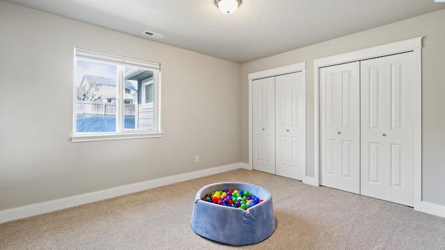 playroom with baseboards, visible vents, and carpet flooring
