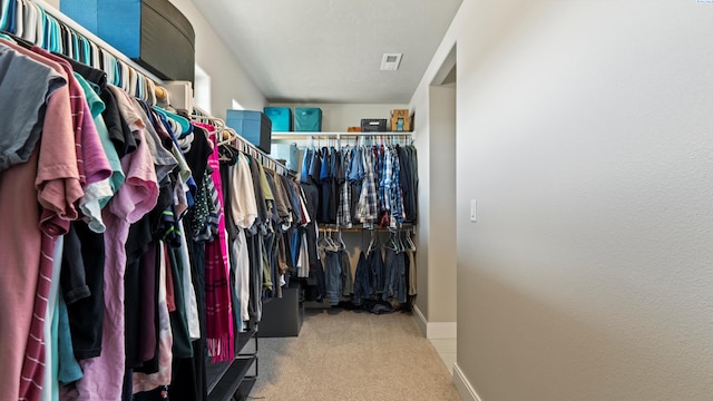 walk in closet featuring carpet floors and visible vents