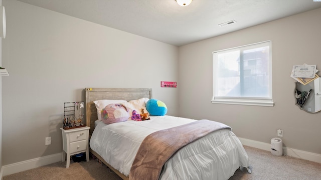 bedroom featuring baseboards, visible vents, and carpet