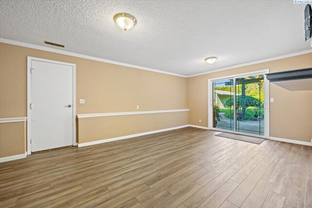 spare room with ornamental molding, light hardwood / wood-style floors, and a textured ceiling