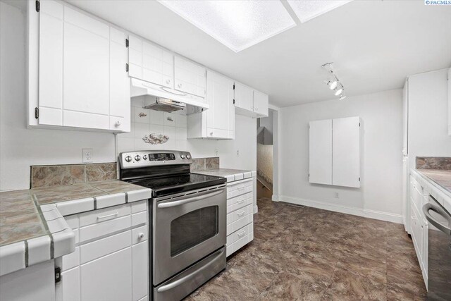 kitchen with stainless steel appliances, tile countertops, and white cabinets