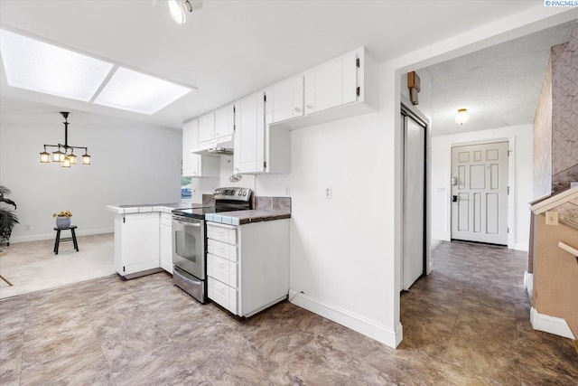 kitchen featuring hanging light fixtures, stainless steel range with electric cooktop, and white cabinets