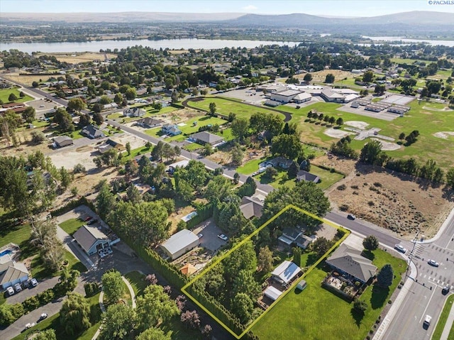 drone / aerial view featuring a water and mountain view