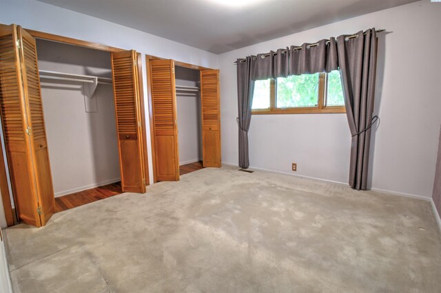 2002 Everest Ave, Richland, WA 99354 - unfurnished bedroom featuring two closets, carpet, and baseboards