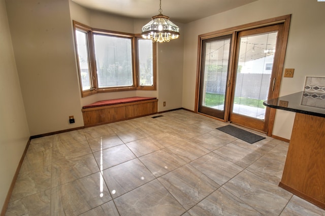 2002 Everest Ave, Richland, WA 99354 - unfurnished dining area featuring plenty of natural light, a chandelier, and baseboards