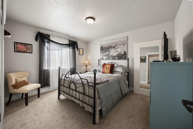 5901 W Ruby St, Pasco, WA 99301 - bedroom featuring light carpet, a textured ceiling, and baseboards