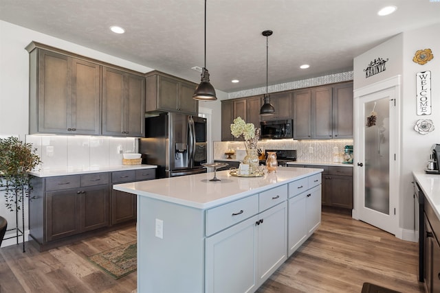 5901 W Ruby St, Pasco, WA 99301 - kitchen featuring stainless steel fridge, tasteful backsplash, wood finished floors, light countertops, and a center island