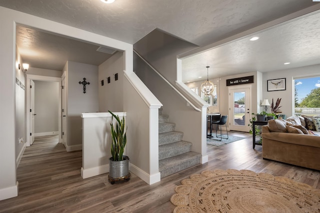 5901 W Ruby St, Pasco, WA 99301 - stairs with wood finished floors, baseboards, a chandelier, recessed lighting, and a textured ceiling
