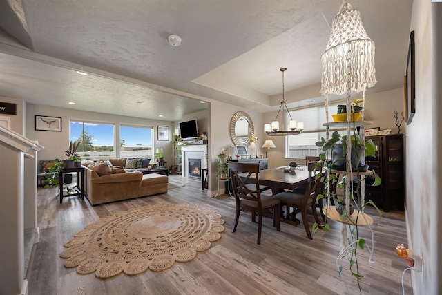 5901 W Ruby St, Pasco, WA 99301 - dining area featuring a chandelier, a glass covered fireplace, healthy amount of natural light, wood finished floors, and recessed lighting