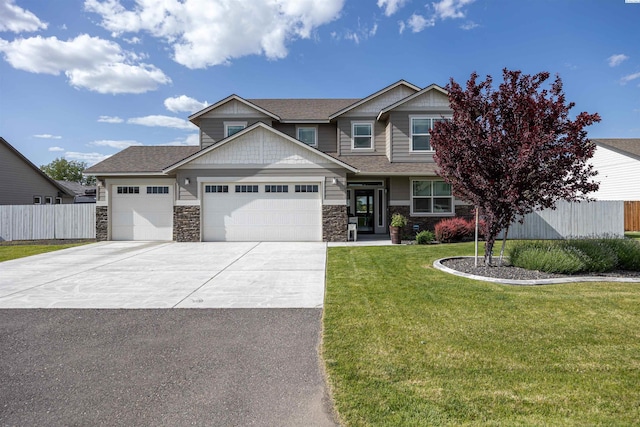 5901 W Ruby St, Pasco, WA 99301 - craftsman-style house with an attached garage, driveway, stone siding, and roof with shingles