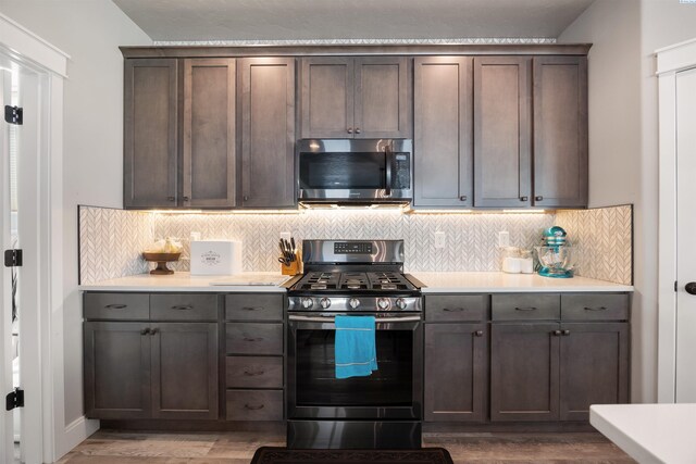 5901 W Ruby St, Pasco, WA 99301 - kitchen with stainless steel appliances, wood finished floors, tasteful backsplash, and light countertops